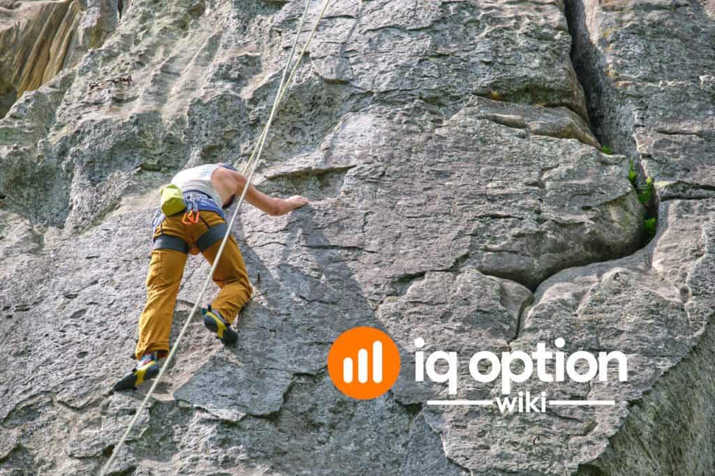 Climber secured by safety equipment on a steep rock face